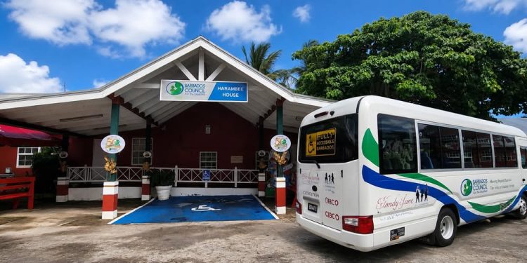 Image of the New BCD Accessible bus parked at the BCD's head quarters at Harambee House.